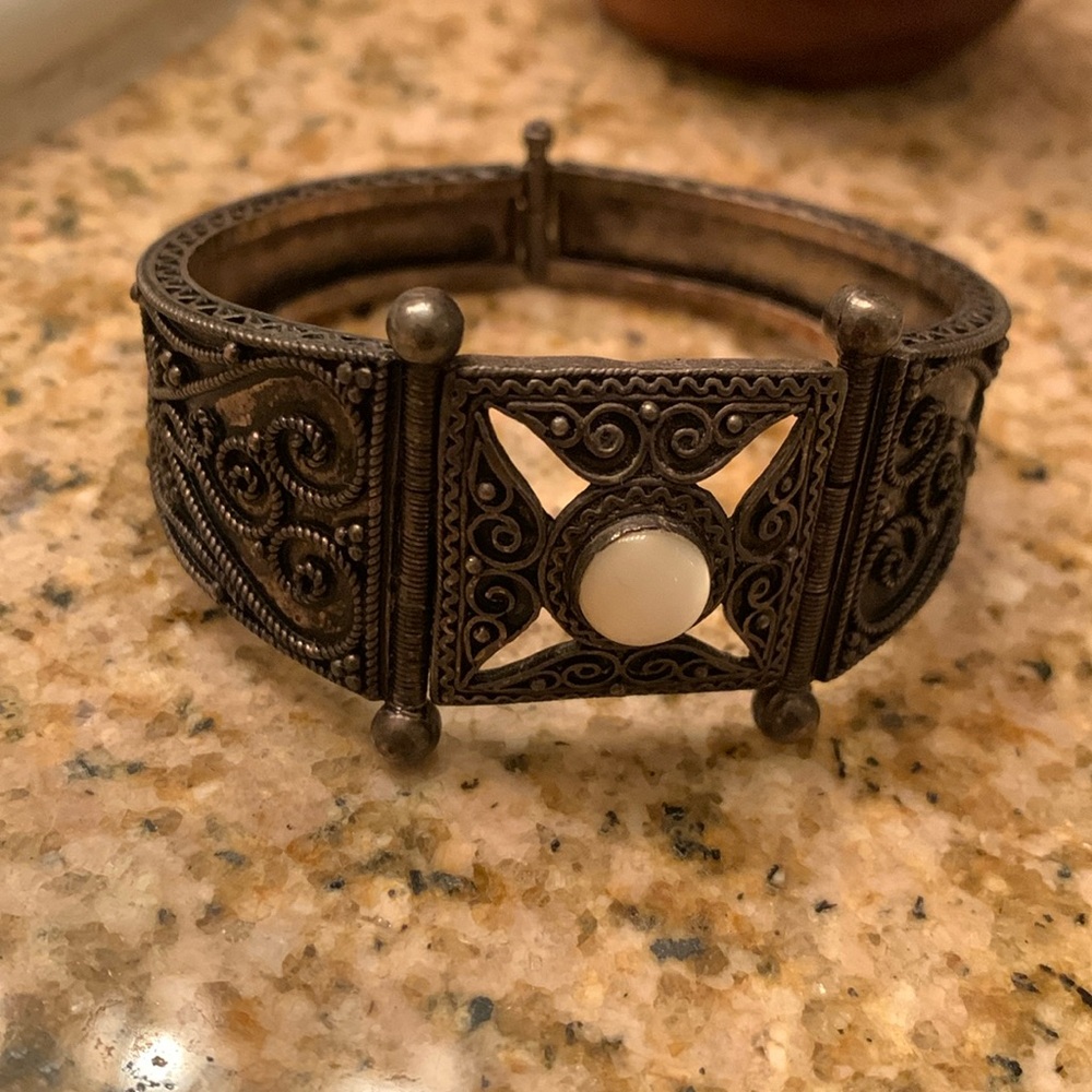 Unique bangle w/ hinged clasp.  Beautiful polished white stone.